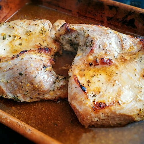 Roasted Spanish pork shoulder sits in an earthenware dish