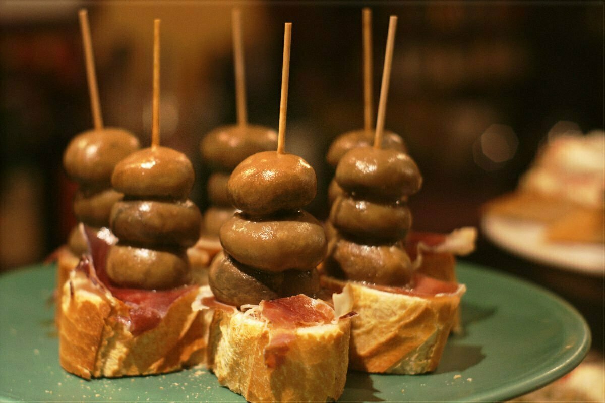 Mushroom skewers are served on a bar counter