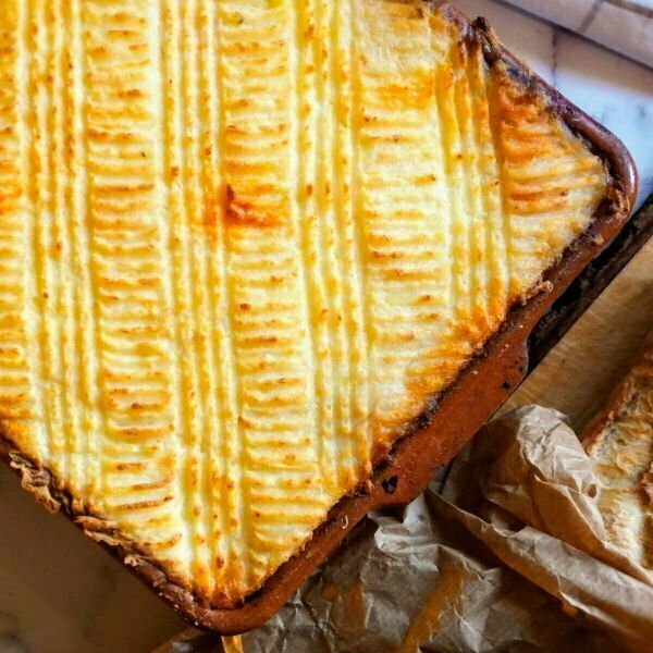 Spanish seafood pie sits in an earthenware dish