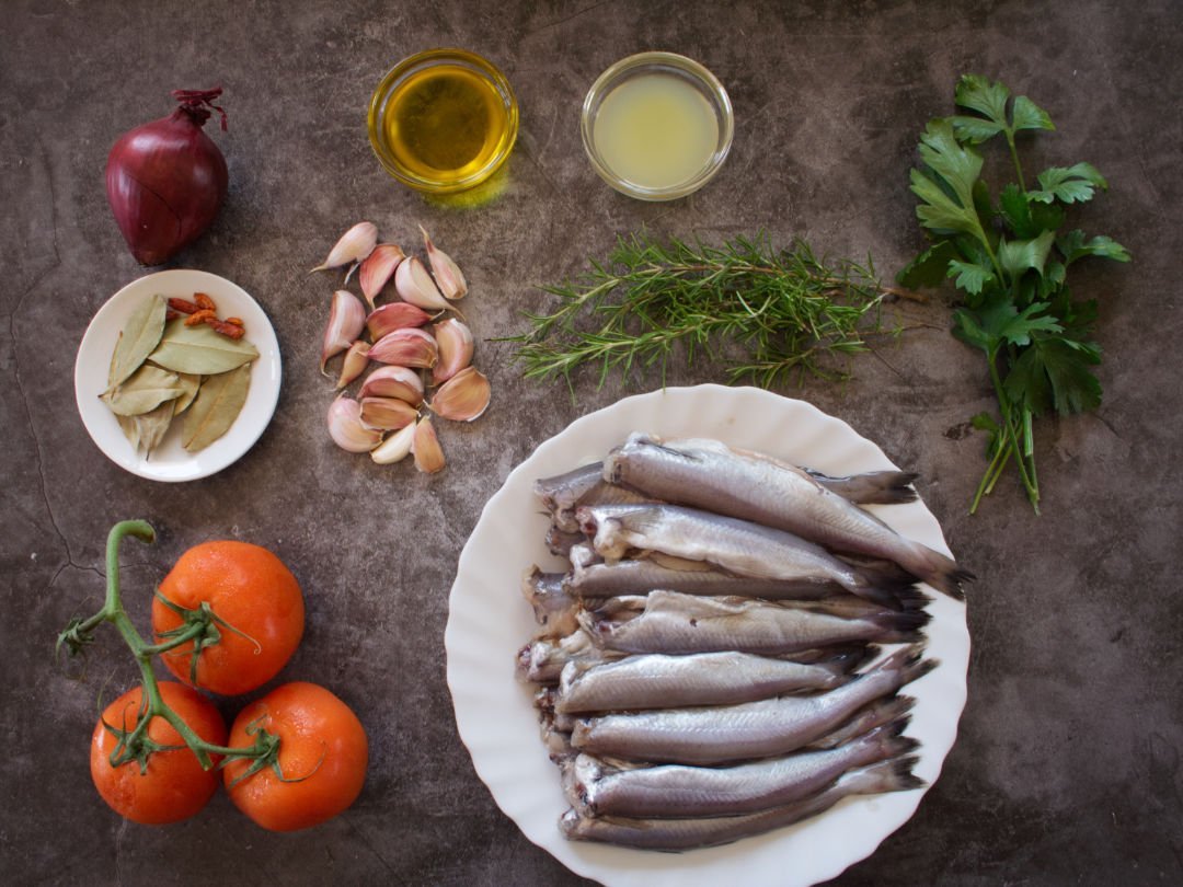 Oven baked fish casserole ingredients sits on a grey granite kitcchen worktop 