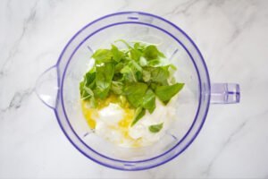 ingredients for cucumber soup sit in a blender