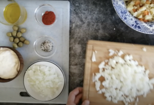 chopped and diced ingredients sit beside some ramakins of salt and pepper