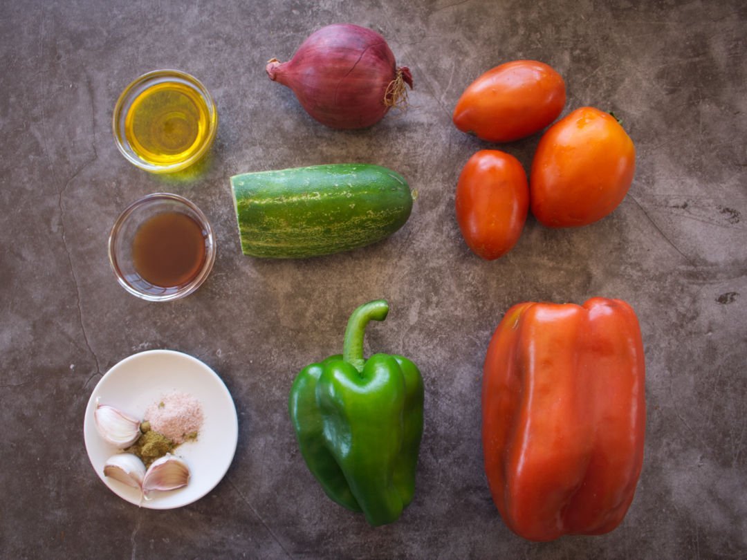 INgredinets required to make pipirrana Spanish salad sits on a. counter.