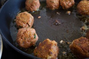 a frying pan with some vegetarian meatballs