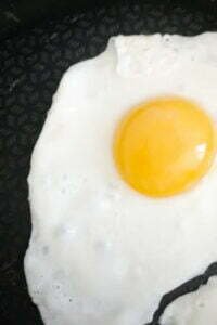 an egg is fried in a pan