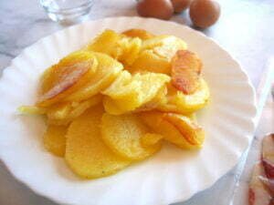 a plate of golen pan-fried potato scallops