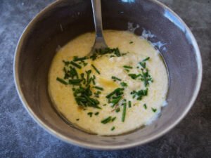 Healthy yogurt salad dressing are mixed in a bowl.