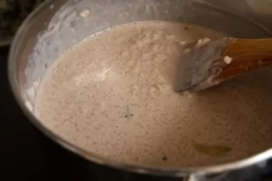 a pot of riice and milk on a stovetop