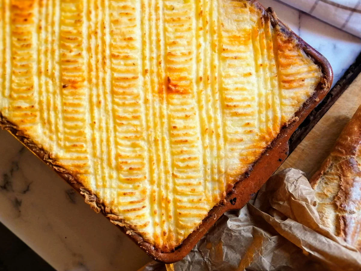 Spanish seafood pie sits in an earthenware dish