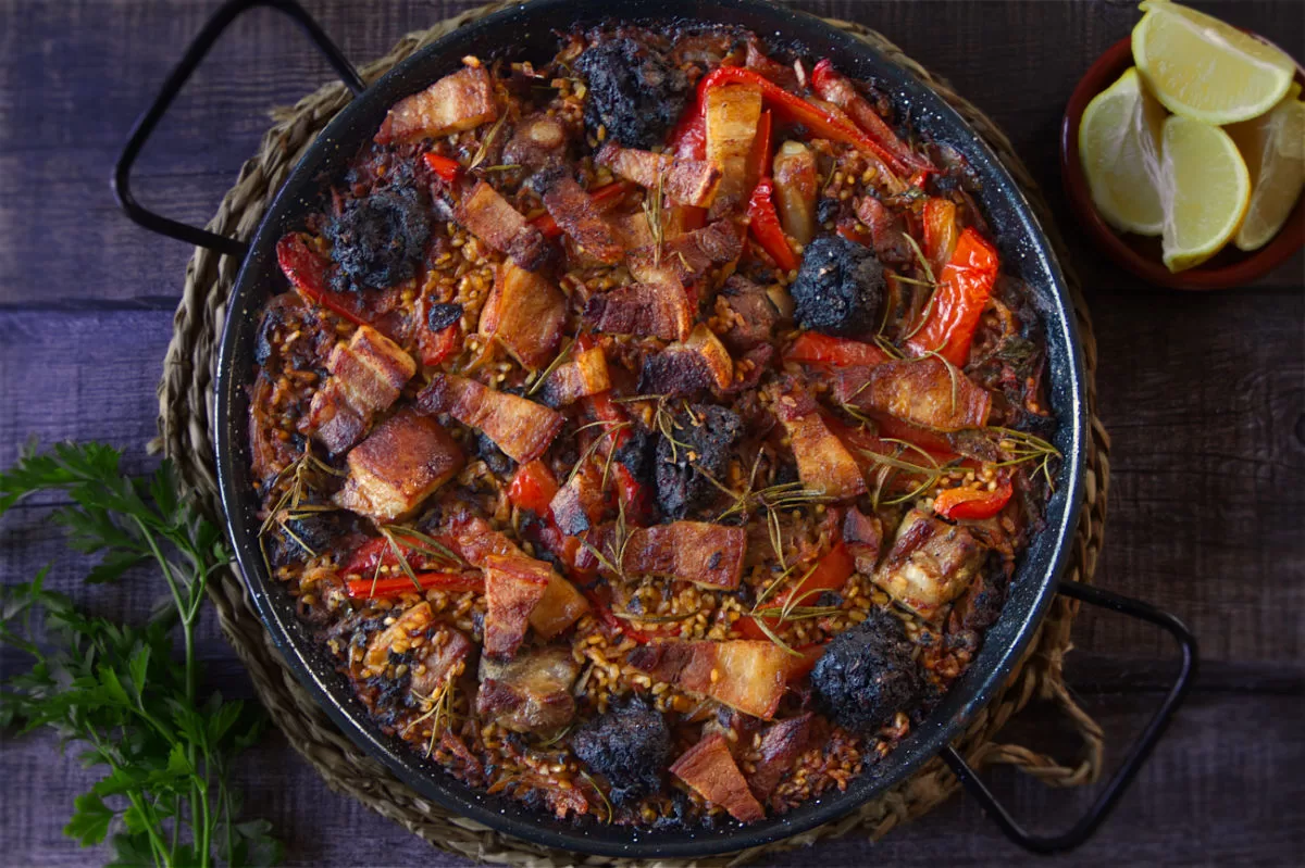 a large pan of arroz al horno sits waiting to be served