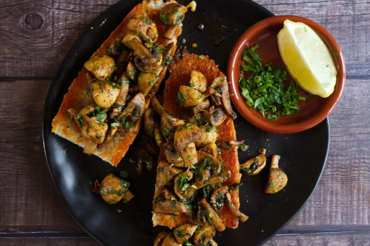 A plate of Spanish garlic mushrooms on some fried bread