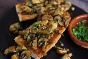 A tapas of Spanish garlic mushrooms on some fried bread