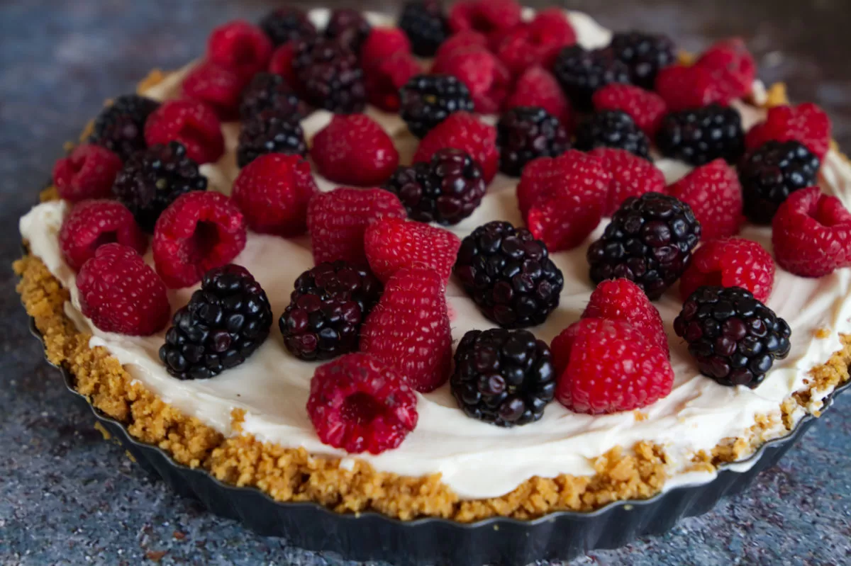 a cheesecake sits in a tart base