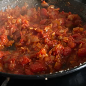 Sofrito sauce simmers in a pan