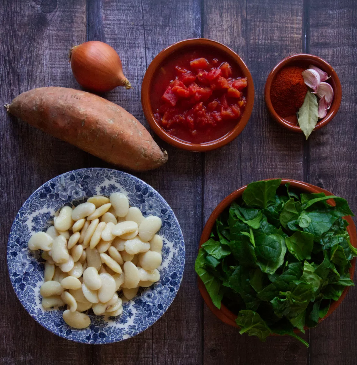 ingredients for making butter bean stew are laid out on a counter