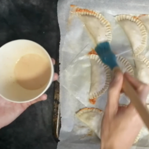 empanadas are basted with egg and paprika.