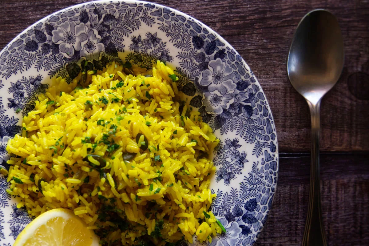 a decorative bowl of Mediterranean yellow rice