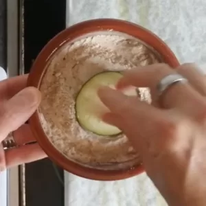 a slice of eggplant is doused in a flour and spices mix