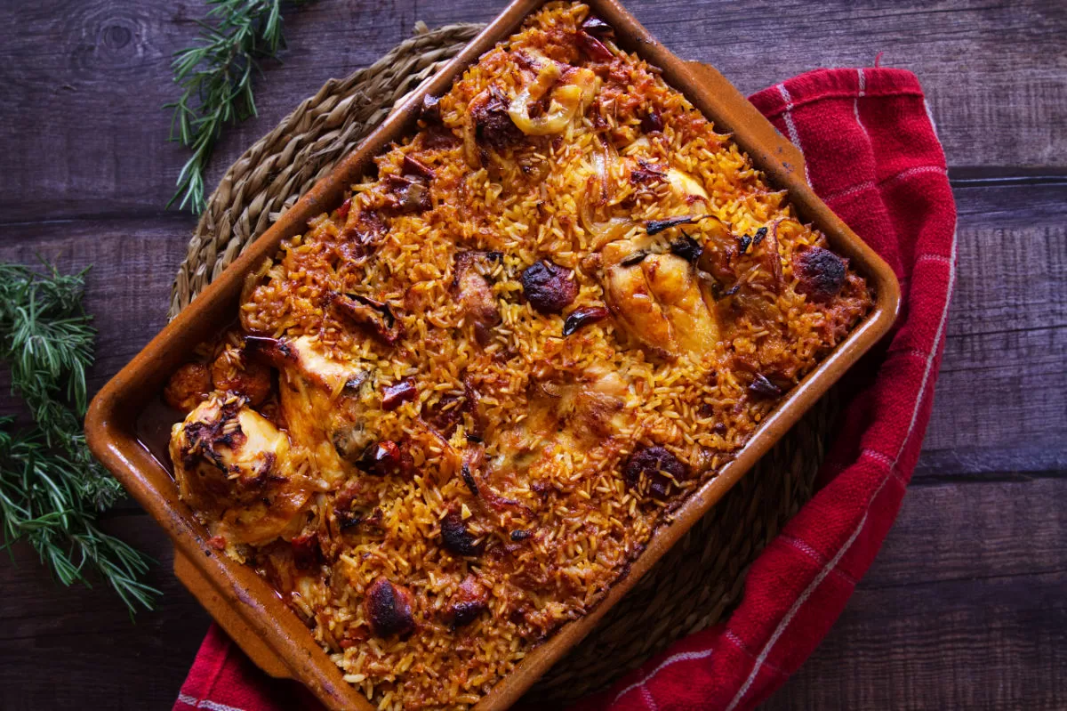 A large pan of spicy chicken, chorizo, and rice