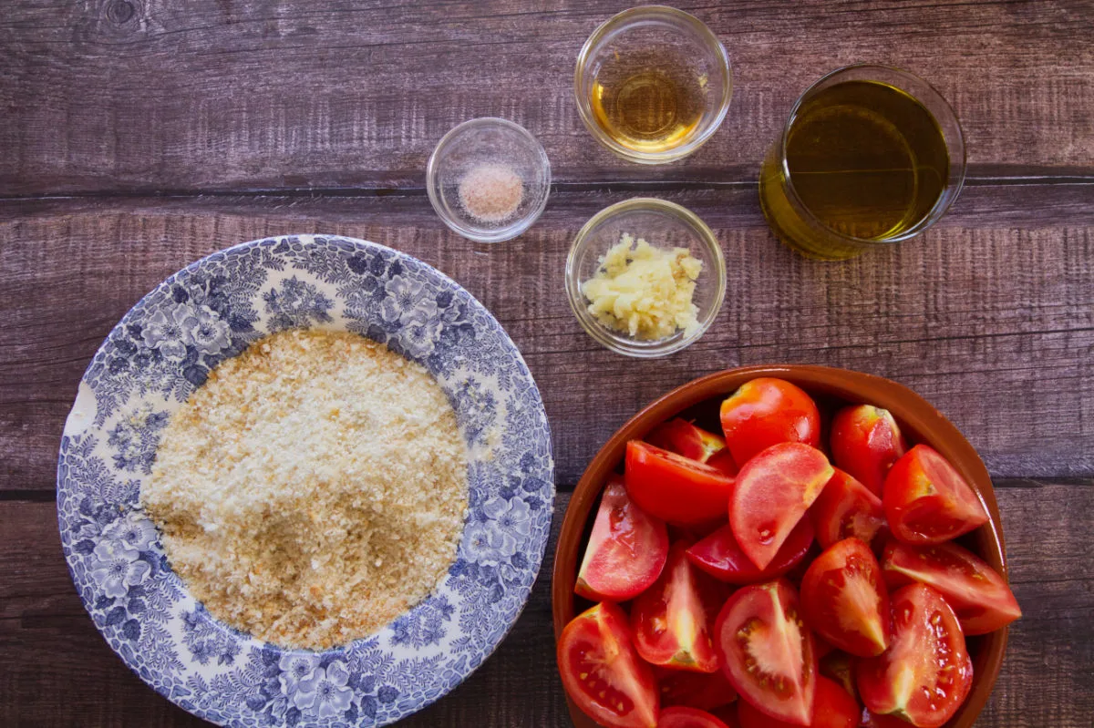 ingredinets for making vegan-friendly salmorejo are laid out o a kitchen counter. 