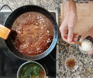 Flour is added to a pan.