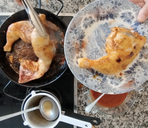 Browned chicken pieces on a plate.