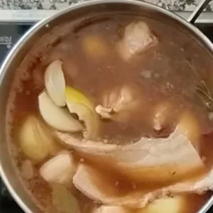 Spicy Spanish-style pork stew simmers on a stovetop.