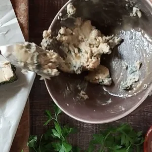 Some blue cheese and sherry are mixed in a small bowl.