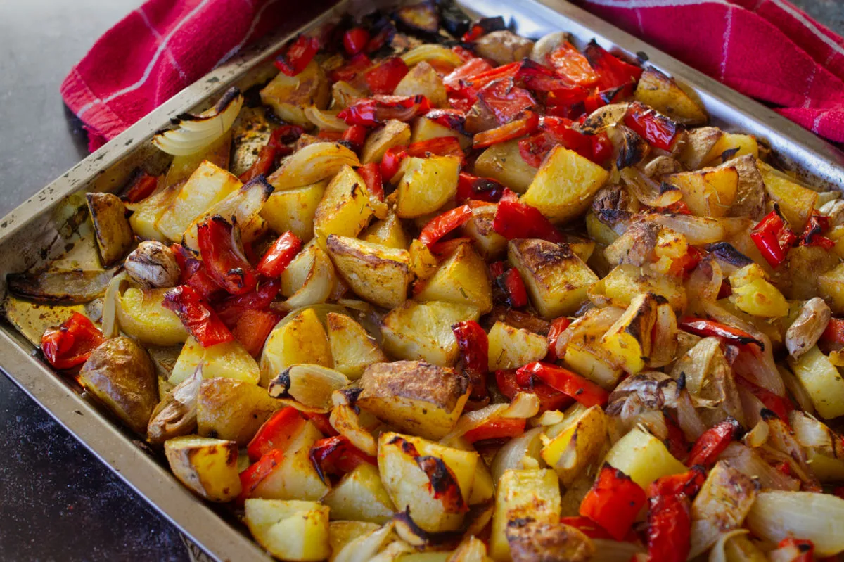 A large baking sheet loaded with cooked Poor Man's potatoes.