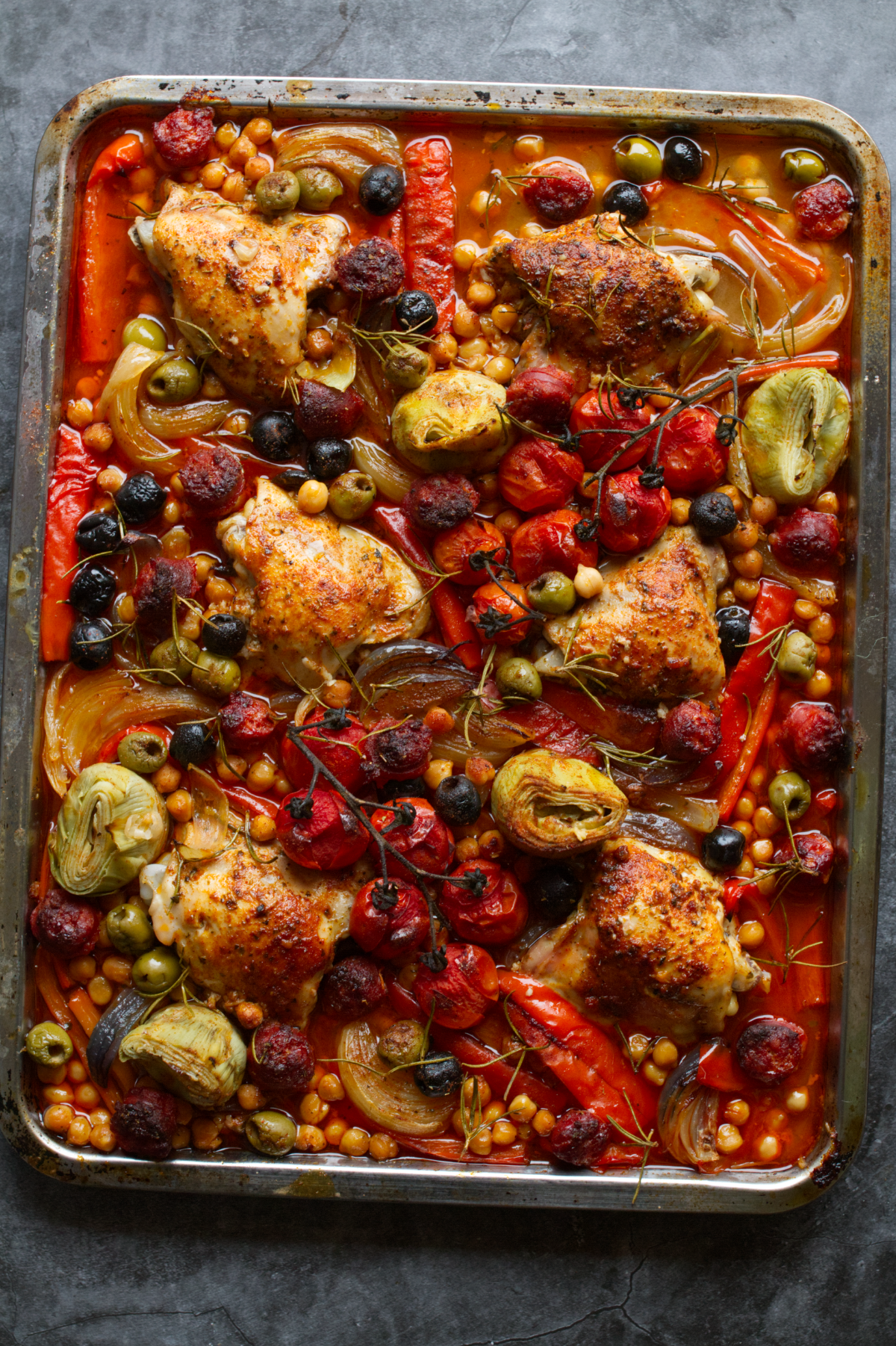 A sheet pan of chicken thighs with chorizo and roasted veg.