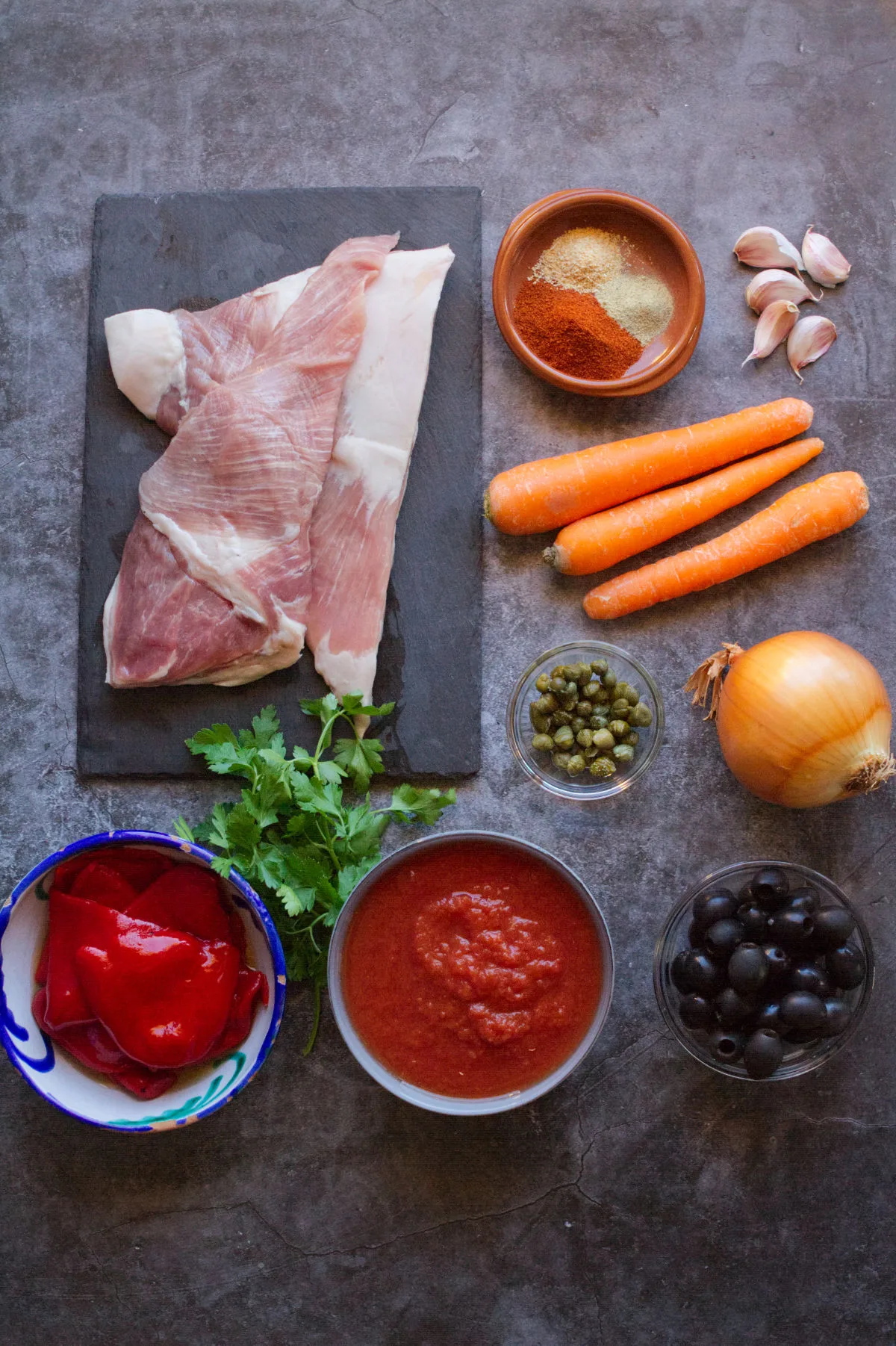 ingredients for making Spanish pork secreto sit on a kitchen counter. 