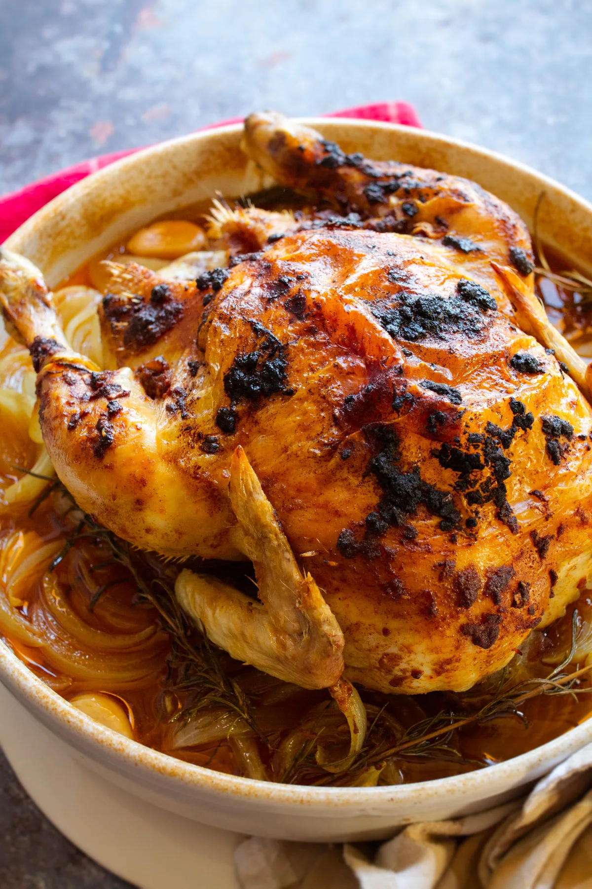 A Spanish roast chicken with a smoked paprika rub sits cooked in a large dish.