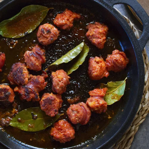 a pan of chorizo cooked in cider.