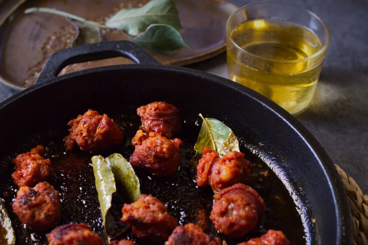 a pan of chorizo cooked in cider.