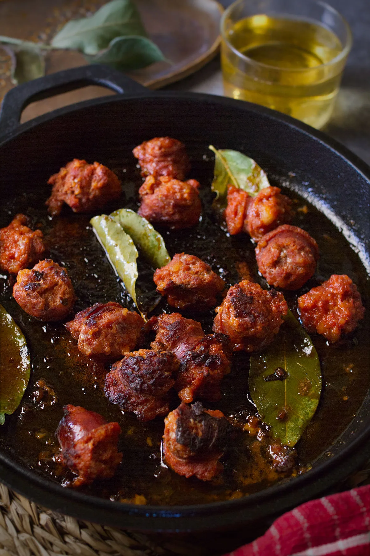 a pan of chorizo cooked in cider.