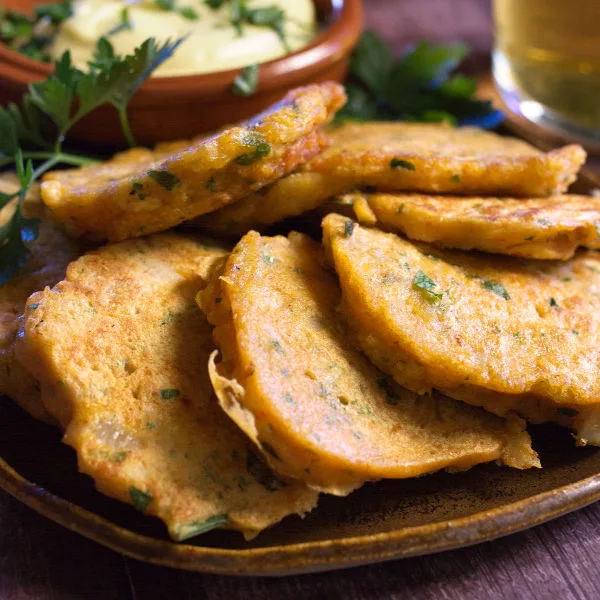 A tapas serving of Spanish cod fritters sits beside some homemade aioli.