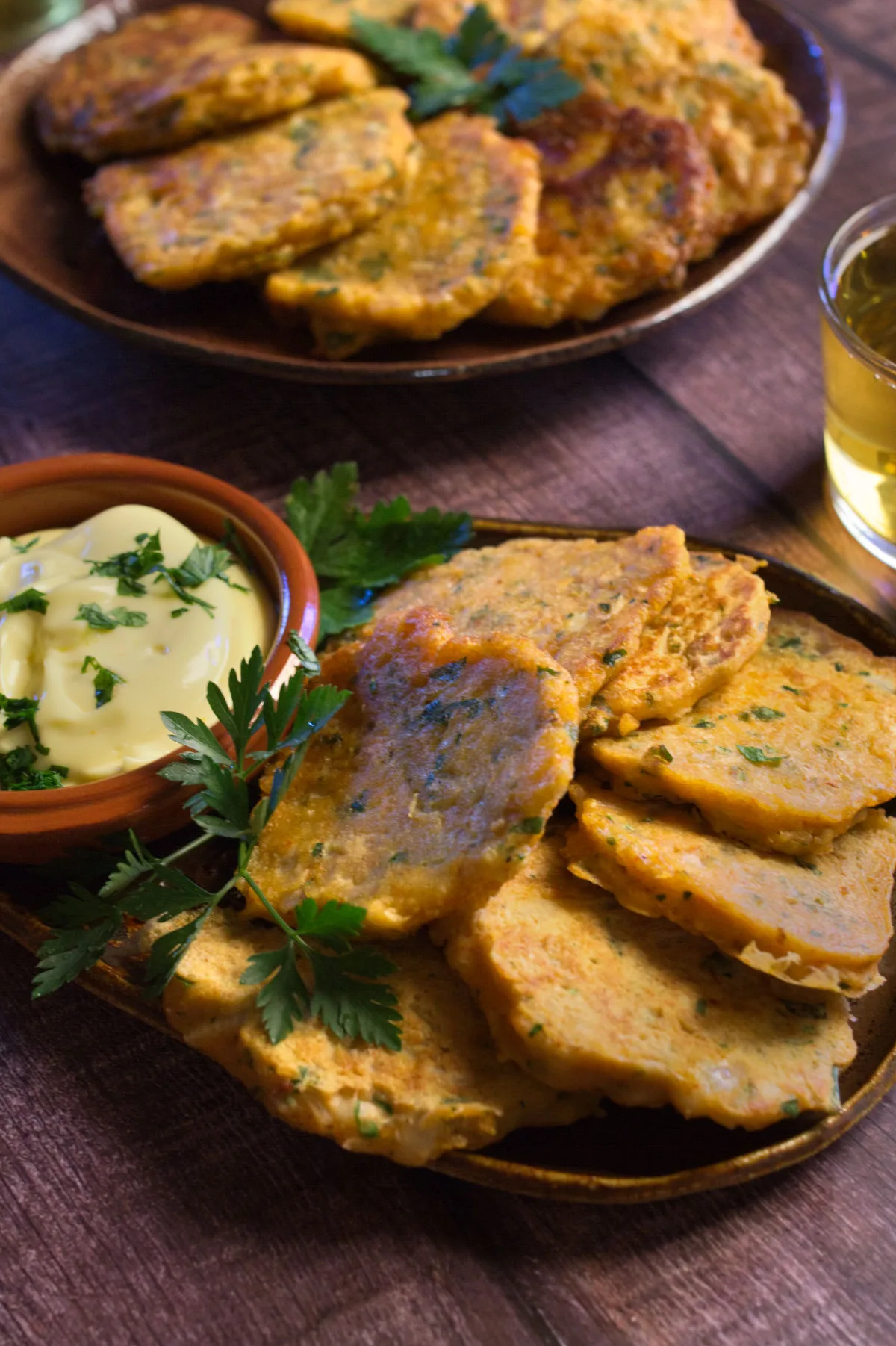 A tapas serving of Spanish cod fritters sits beside some homemade aioli.