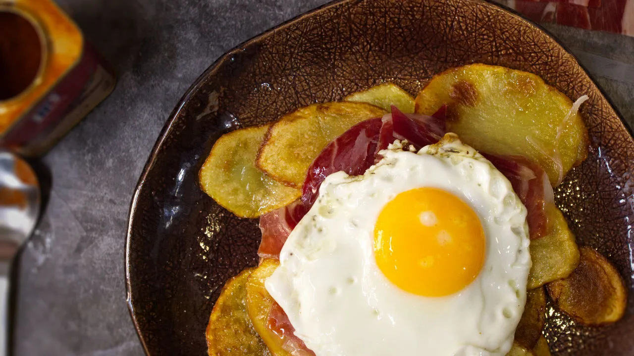 a plate of Spanish-style ham, egg and chips