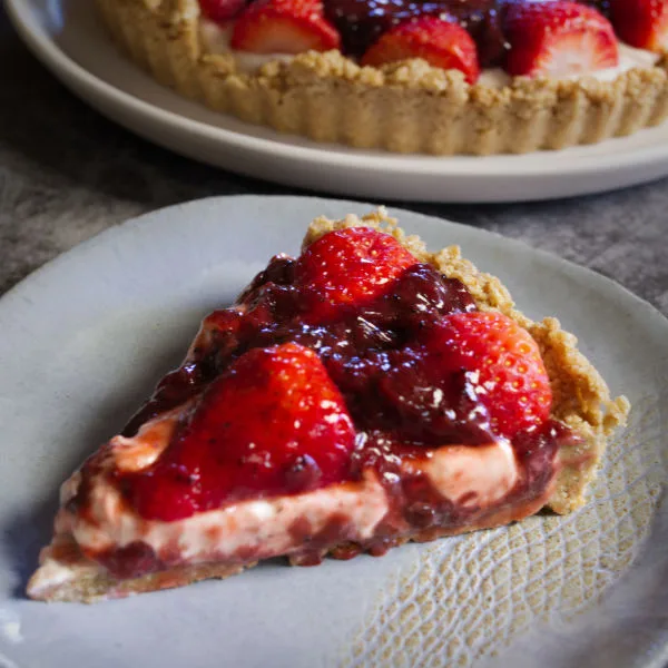 A slice of a no-bake strawberry cheesecake.