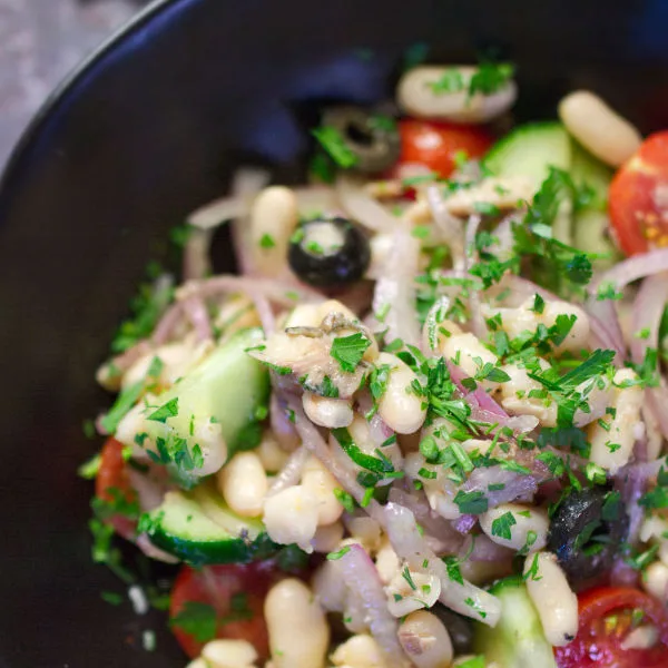 A bowl of white bean salad with sardines