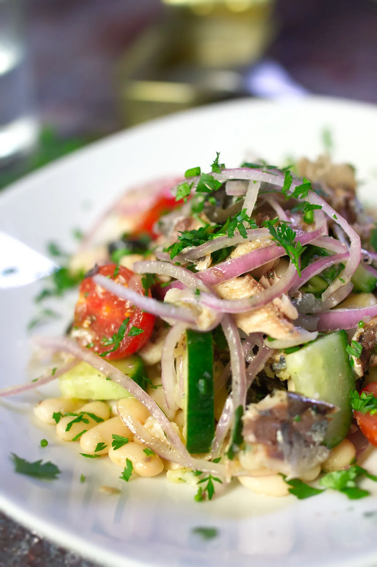 A bowl of white bean salad with sardines